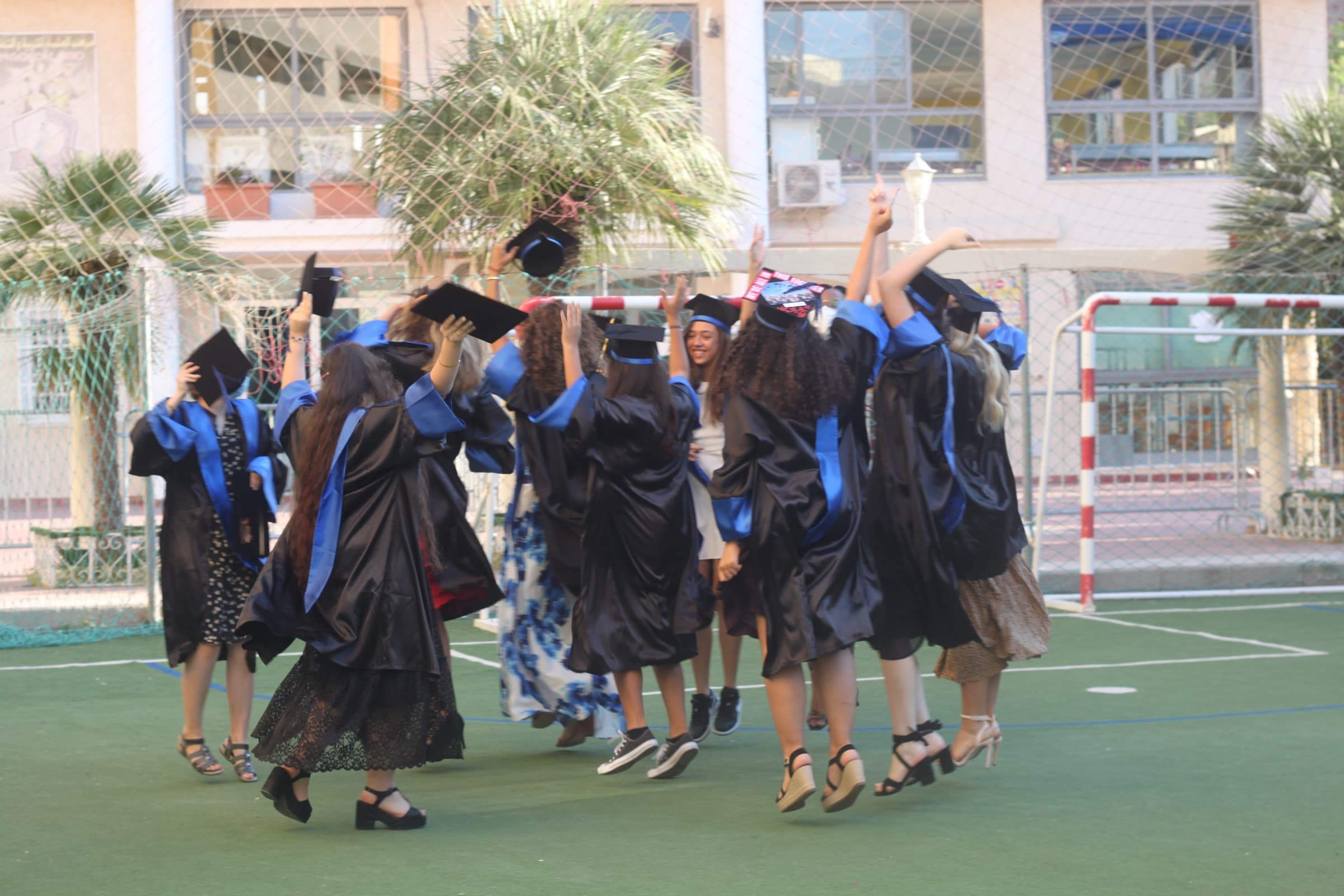 SIS graduates celebrating on the school court in Sousse